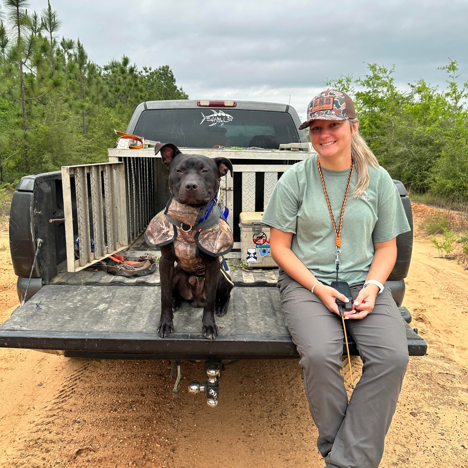 Pitbull with catch vest and Garmin TT25 collar and ODS Customer with Alpha 300 handheld