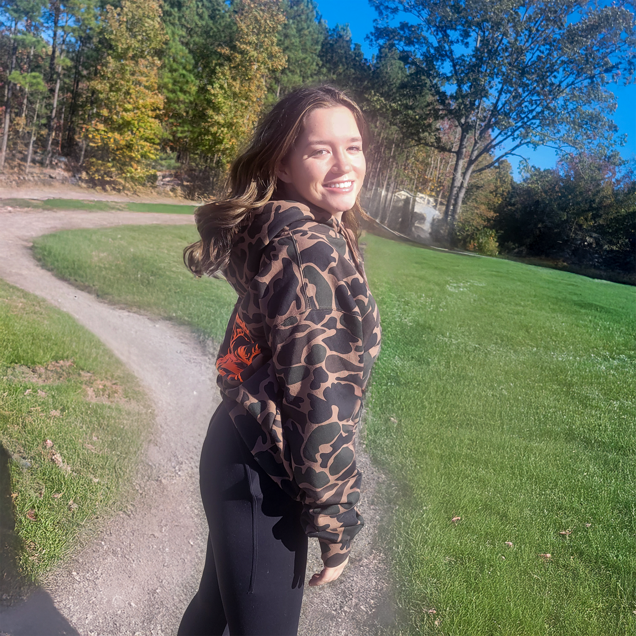 side view of emmy in camo hoodie