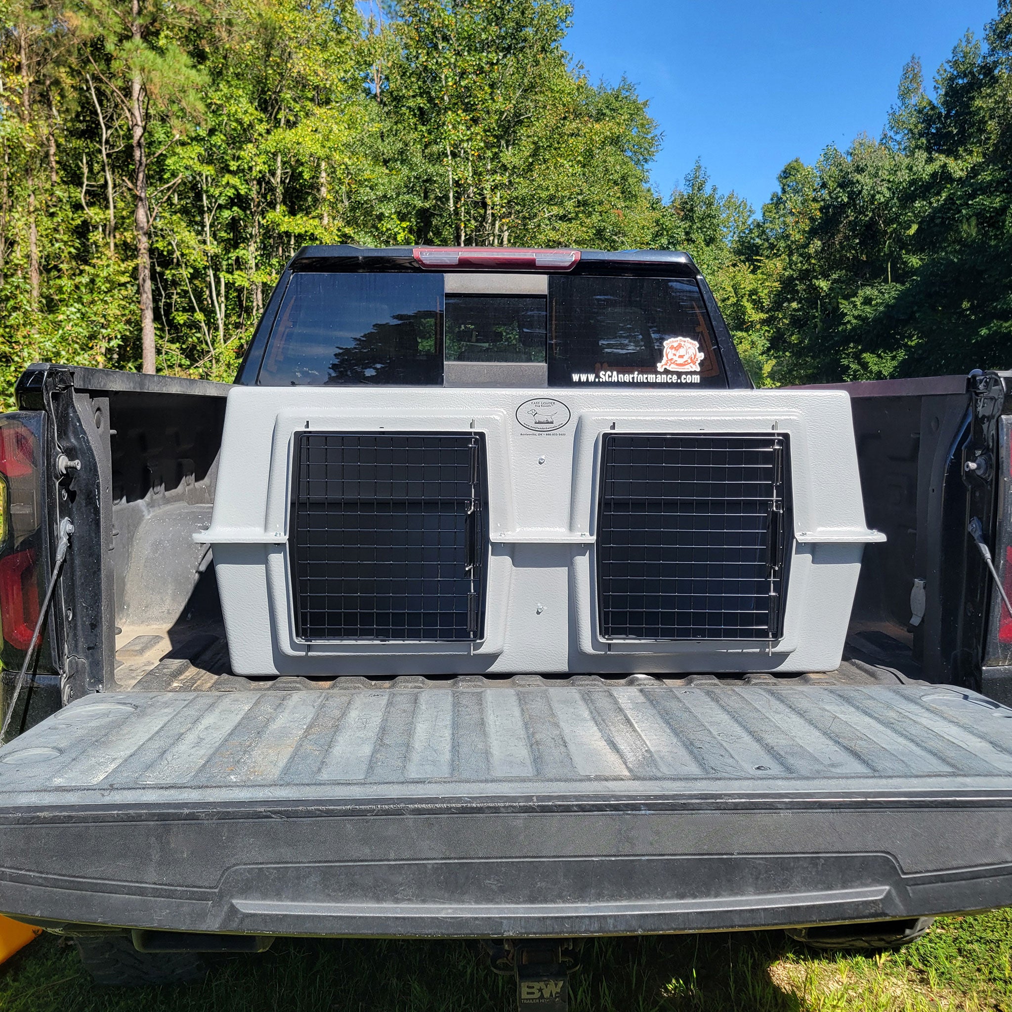 The Original By Easy Loader Dog Kennels on the back of a pickup truck