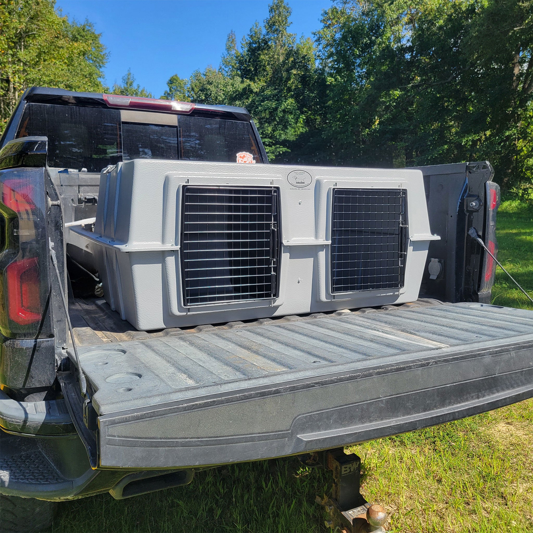 The Original By Easy Loader Dog Kennels on the back of a pickup truck