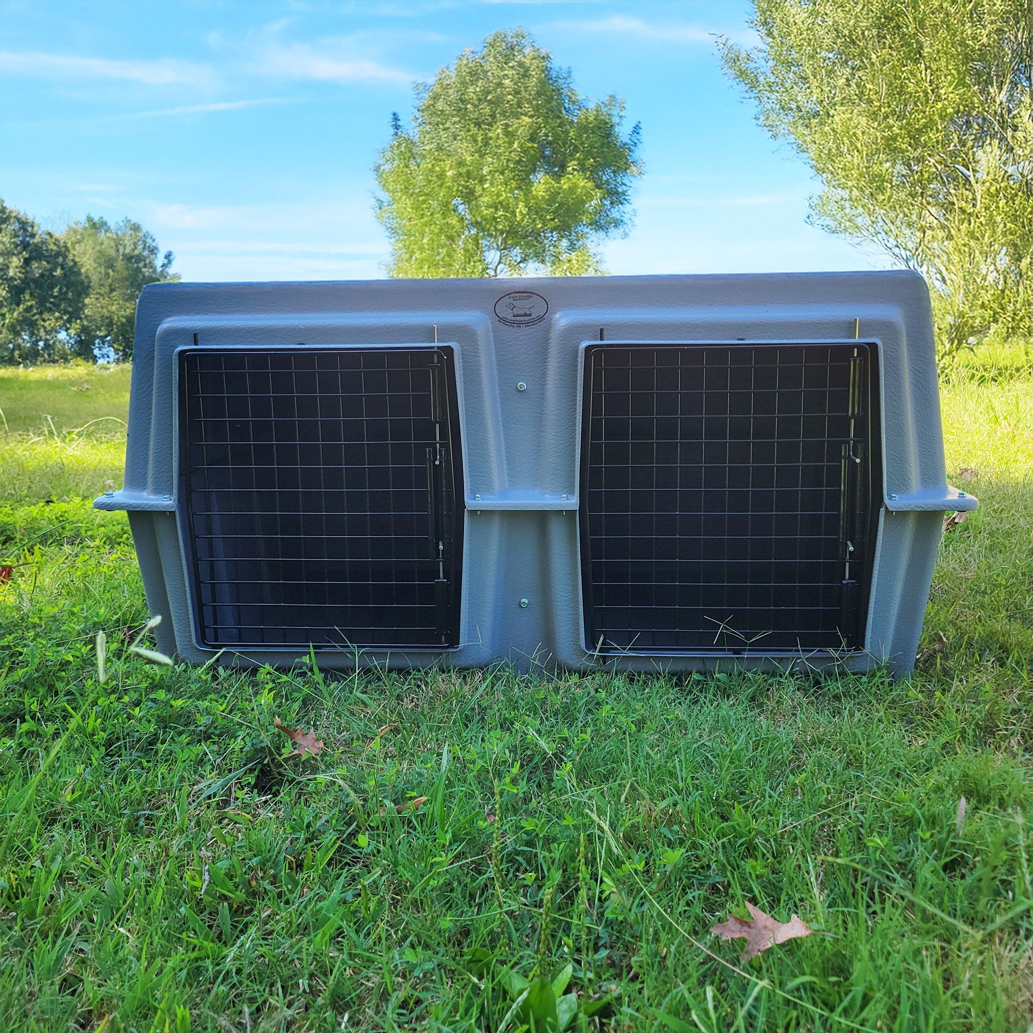 The Duece Kennel by Easy Loader Kennels in a grassy field