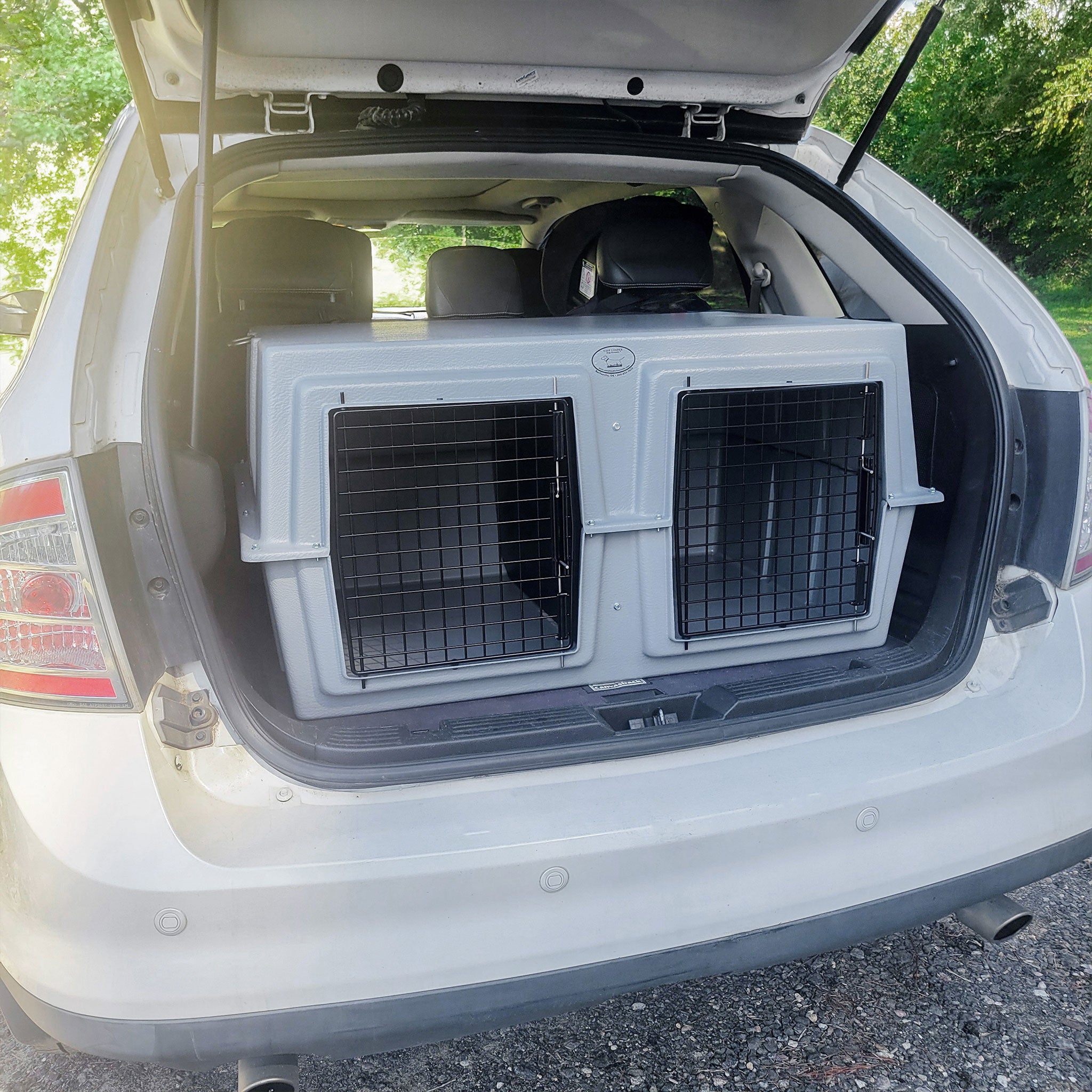 The Duece Kennel by Easy Loader Kennels in the truck of an SUV