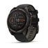fenix 8 47 mm Solar Sapphire Carbon Gray DLC Titanium with Black Pebble Gray Silicone rear facing showing charging station front facing showing menu screen with time